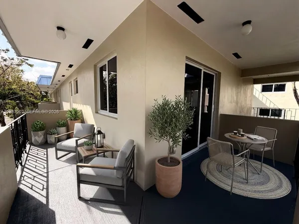 a view of a house with potted plants