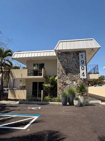 a kitchen with white cabinets and black appliances