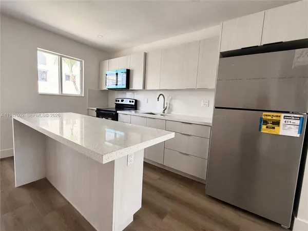 a view of a hallway view with wooden floor and living room