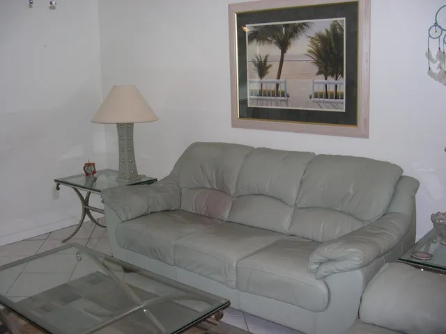 a living room with furniture and a wall painting