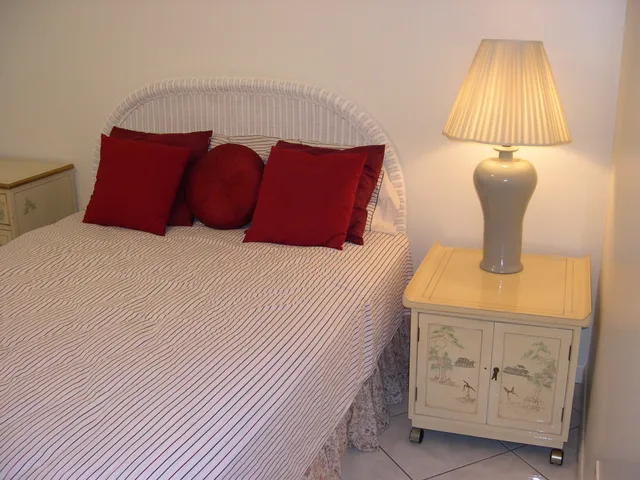 a bedroom with a bed and lamp