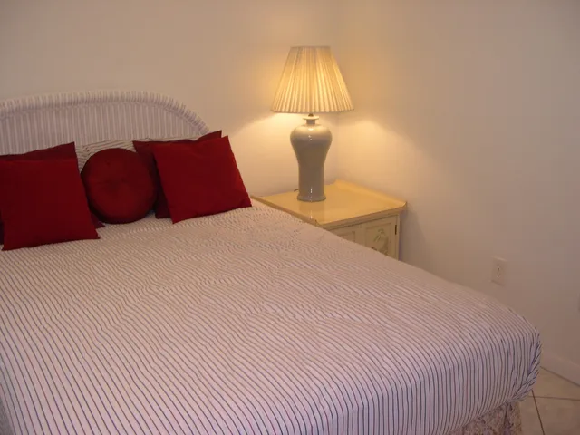 a bedroom with a bed and a lamp