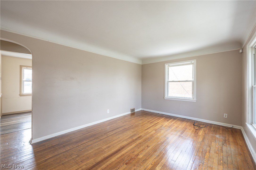 4344 West Anderson Road South Euclid, OH 44121 - Photo 3 of 14 Spare room featuring crown molding and hardwood / wood-style floors