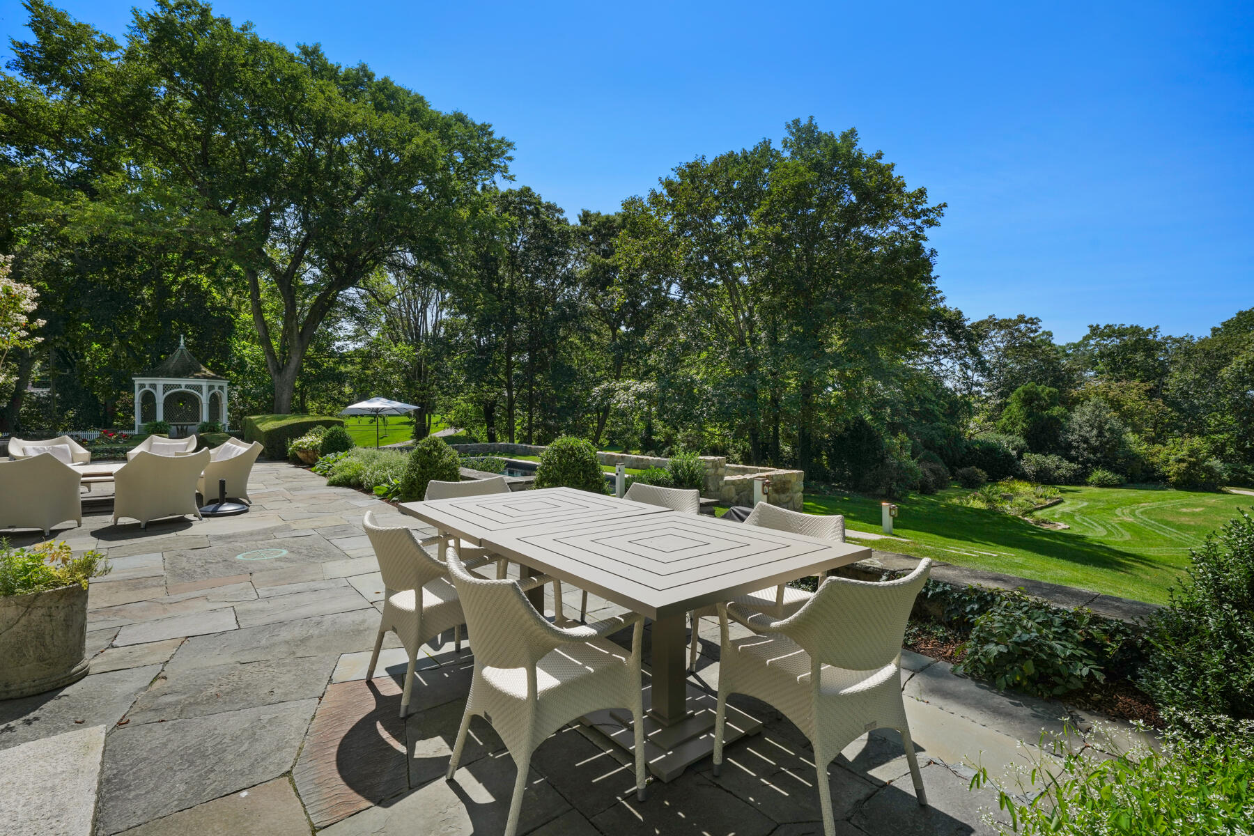 503 Sippewissett Road Falmouth, MA 02540 - Photo 33 of 45 a view of a patio with table and chairs and potted plants with large tree