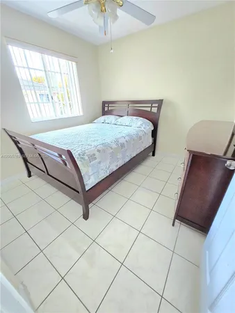 a bedroom with a bed and a chair