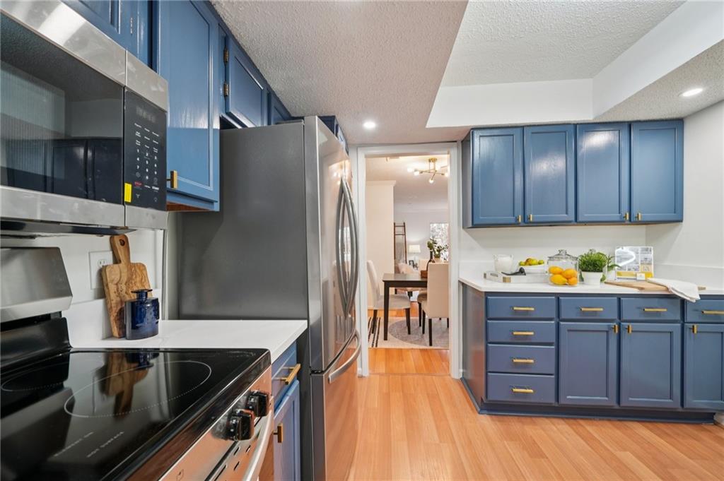 1750 Clairmont Road, Unit 8 Decatur, GA 30033 - Photo 11 of 28 a kitchen with stainless steel appliances granite countertop a refrigerator and a stove top oven