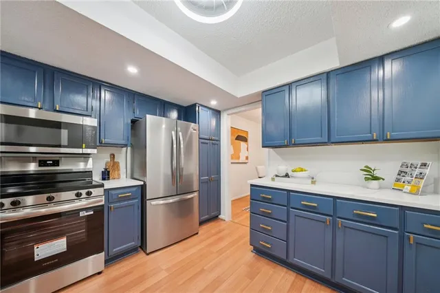 a kitchen with wooden cabinets and stainless steel appliances