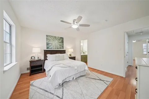 a bedroom with a large bed and a chandelier