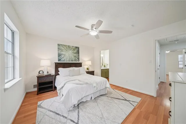 a bedroom with a large bed and a chandelier