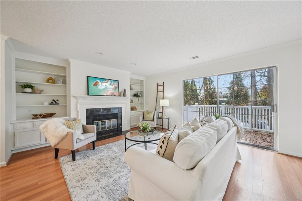 1750 Clairmont Road, Unit 8 Decatur, GA 30033 - Photo 5 of 28 a living room with furniture a fireplace and a table