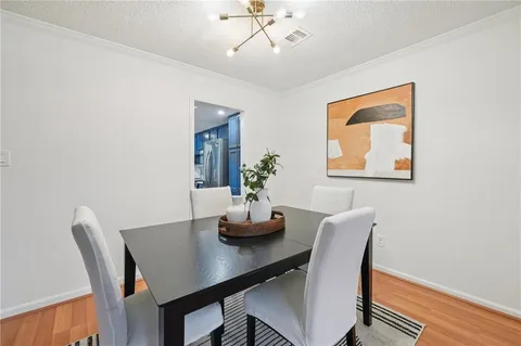 a dining room with furniture and wooden floor