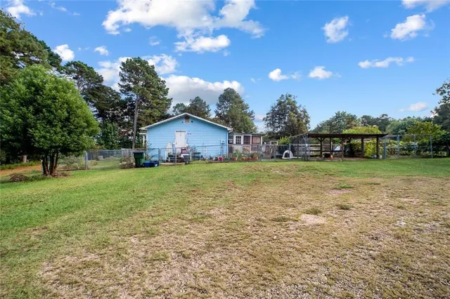 an aerial view of residential houses with outdoor space and swimming pool