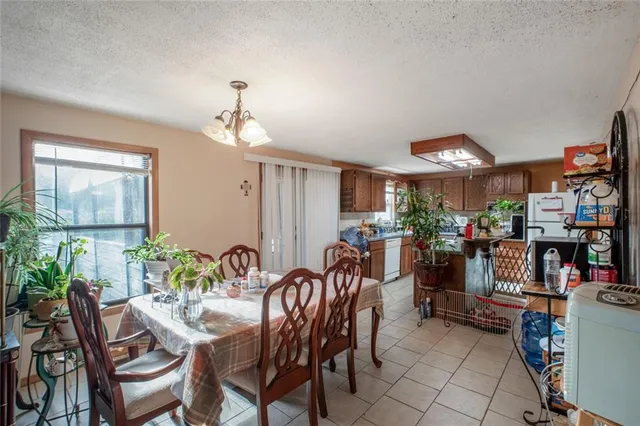 a kitchen with granite countertop lots of white stainless steel appliances a sink and cabinets