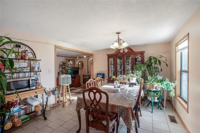 a kitchen with a sink a stove and chairs