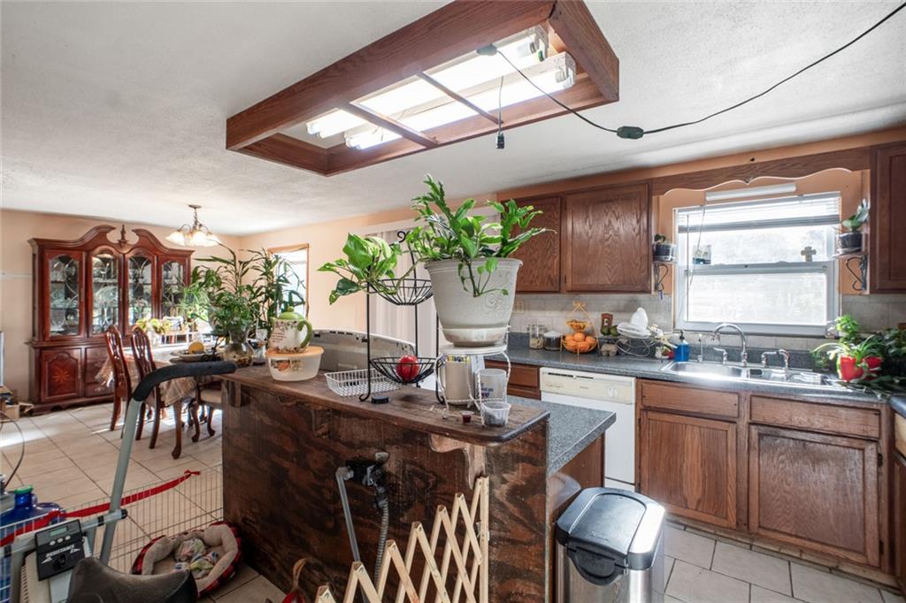 5570 Bold Springs Road Dacula, GA 30019 - Photo 24 of 60 a kitchen with a sink a stove and chairs