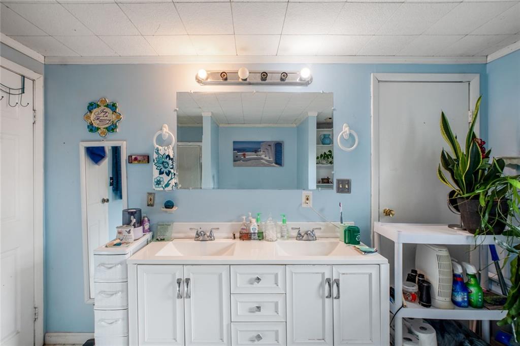 5570 Bold Springs Road Dacula, GA 30019 - Photo 26 of 60 a bathroom with a sink a mirror and a shower