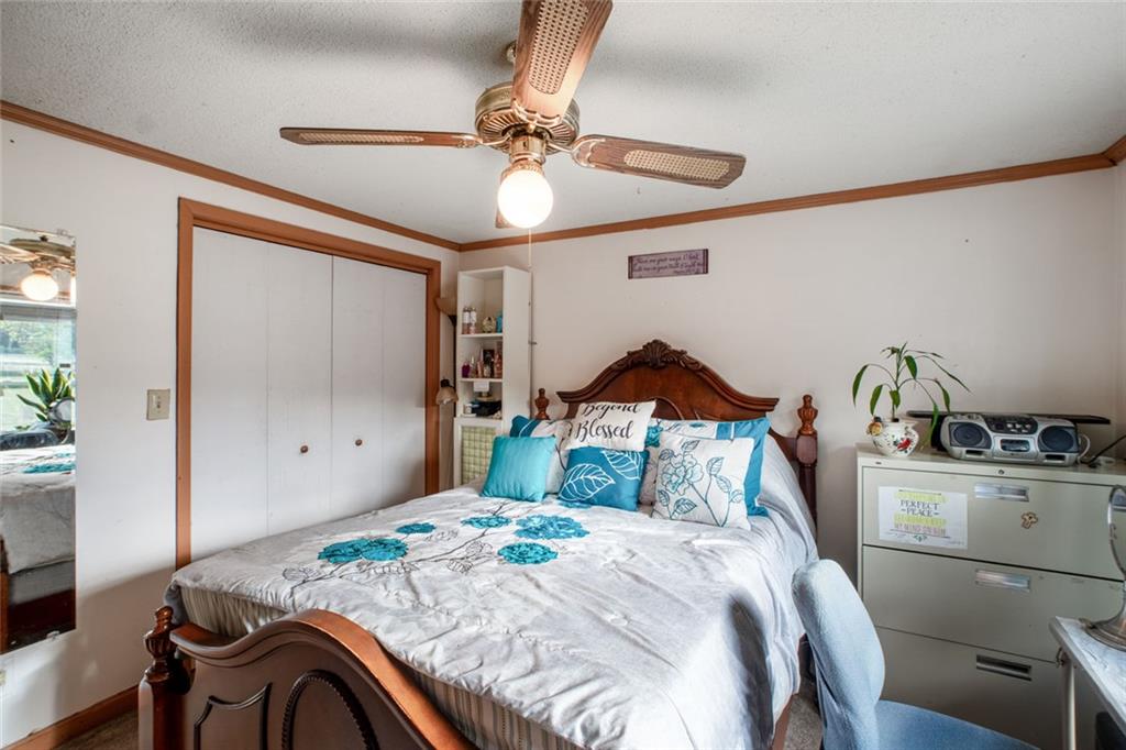 5570 Bold Springs Road Dacula, GA 30019 - Photo 32 of 60 a bedroom with a bed and a chandelier