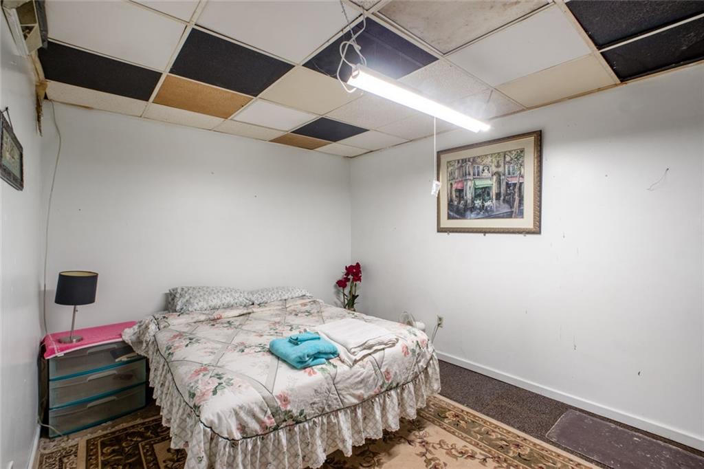 5570 Bold Springs Road Dacula, GA 30019 - Photo 36 of 60 a bedroom with a bed and a bookshelf