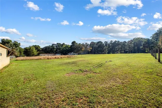 a view of yard with swimming pool and outdoor seating