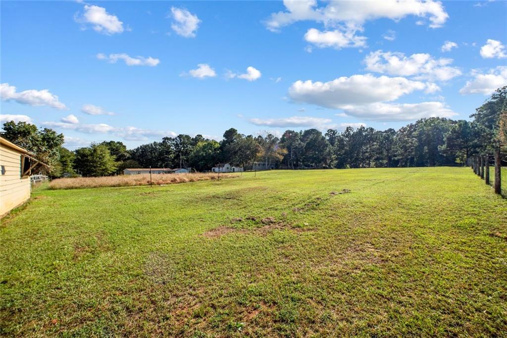 5570 Bold Springs Road Dacula, GA 30019 - Photo 44 of 60 a view of yard with swimming pool and trees in the background
