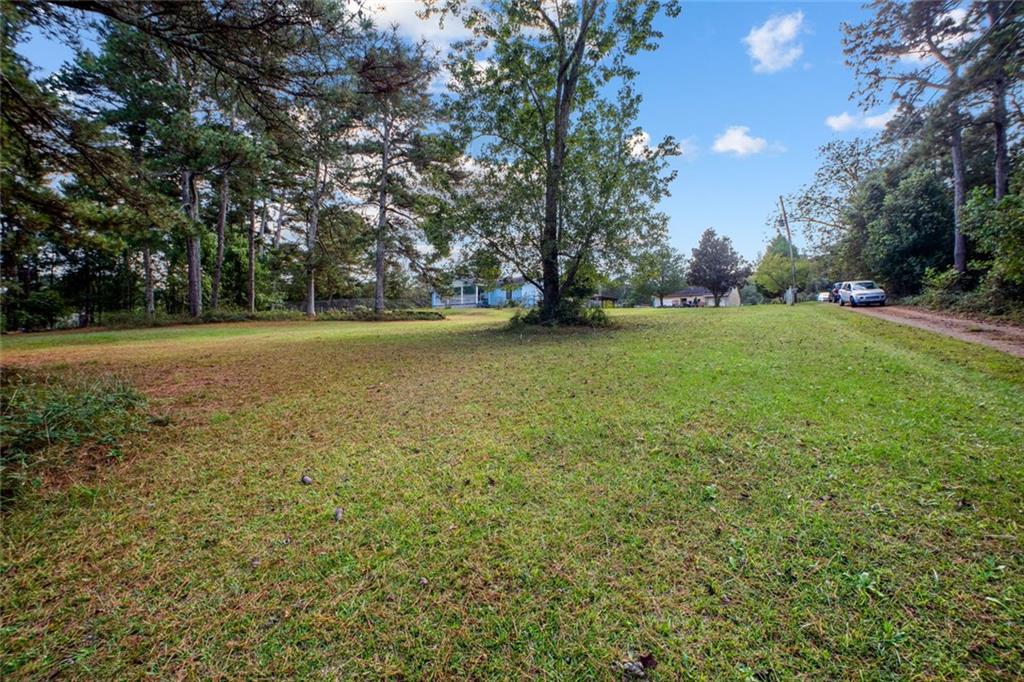 5570 Bold Springs Road Dacula, GA 30019 - Photo 57 of 60 a view of a field with trees in the background