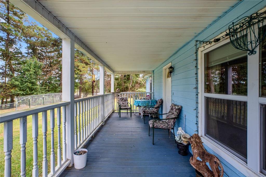 5570 Bold Springs Road Dacula, GA 30019 - Photo 6 of 60 a view of a porch with chairs and backyard