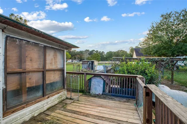 a balcony with wooden floor and outdoor space