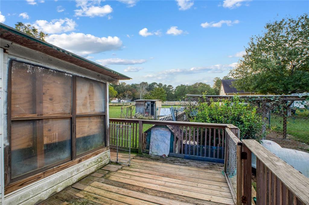 5570 Bold Springs Road Dacula, GA 30019 - Photo 9 of 60 a balcony with wooden floor and outdoor space
