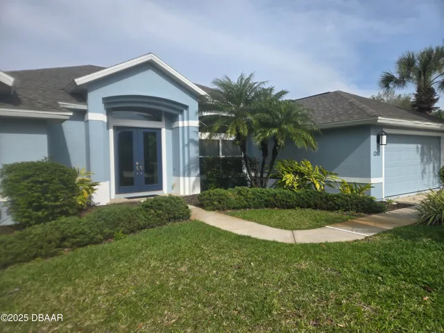 a front view of a house with garden