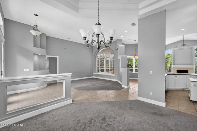 a kitchen with granite countertop a oven a white cabinets and couches