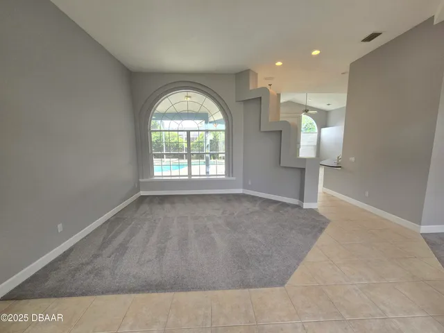a large white kitchen with a large counter top and sink
