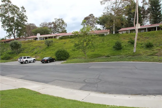an open kitchen with wooden floor and a large window