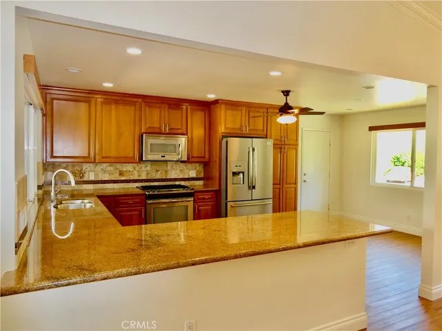 a view of a room with wooden floor and a window