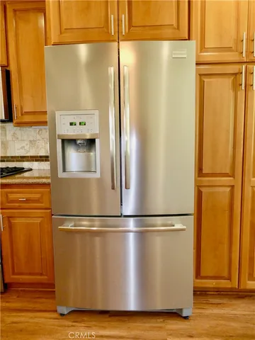 a view of a room with wooden floor and a window