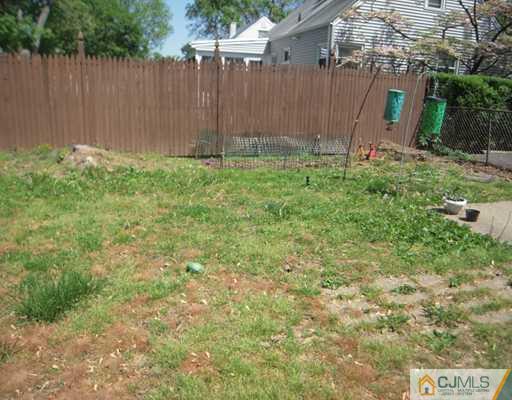 18 Racetrack Road East Brunswick, NJ 08816 - Photo 12 of 13 a garden with trees in front of the house