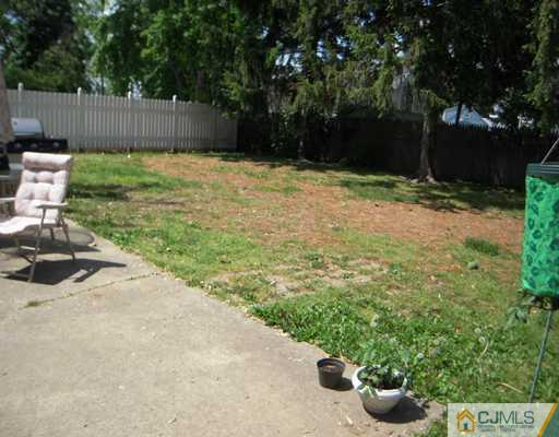18 Racetrack Road East Brunswick, NJ 08816 - Photo 13 of 13 a backyard of a house with lots of green space and fountain