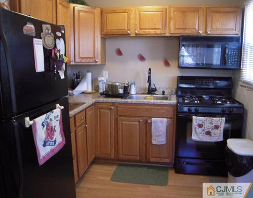 18 Racetrack Road East Brunswick, NJ 08816 - Photo 4 of 13 a kitchen with stainless steel appliances granite countertop a stove and cabinets