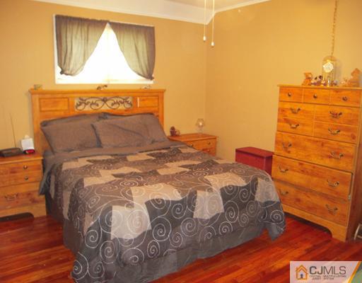 18 Racetrack Road East Brunswick, NJ 08816 - Photo 6 of 13 a bedroom with a bed and a mirror