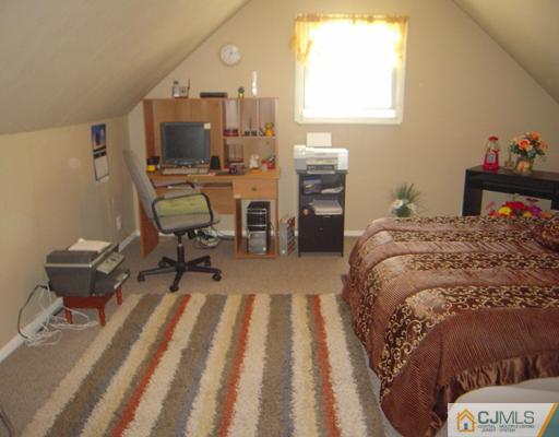 18 Racetrack Road East Brunswick, NJ 08816 - Photo 8 of 13 a bedroom with a bed and furniture