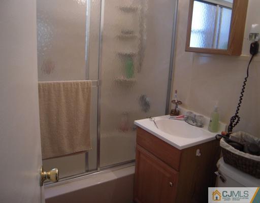 18 Racetrack Road East Brunswick, NJ 08816 - Photo 10 of 13 a bathroom with a sink a mirror and shower