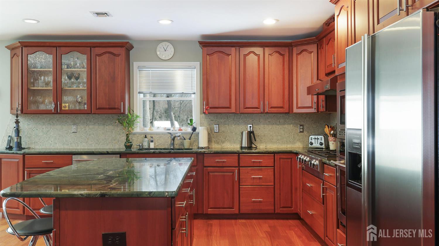 142 Monmouth Road Monroe Township, NJ 08831 - Photo 15 of 33 a kitchen with stainless steel appliances granite countertop a stove a sink and a microwave