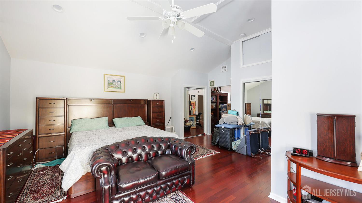 142 Monmouth Road Monroe Township, NJ 08831 - Photo 19 of 33 a bedroom with a bed and wooden floor