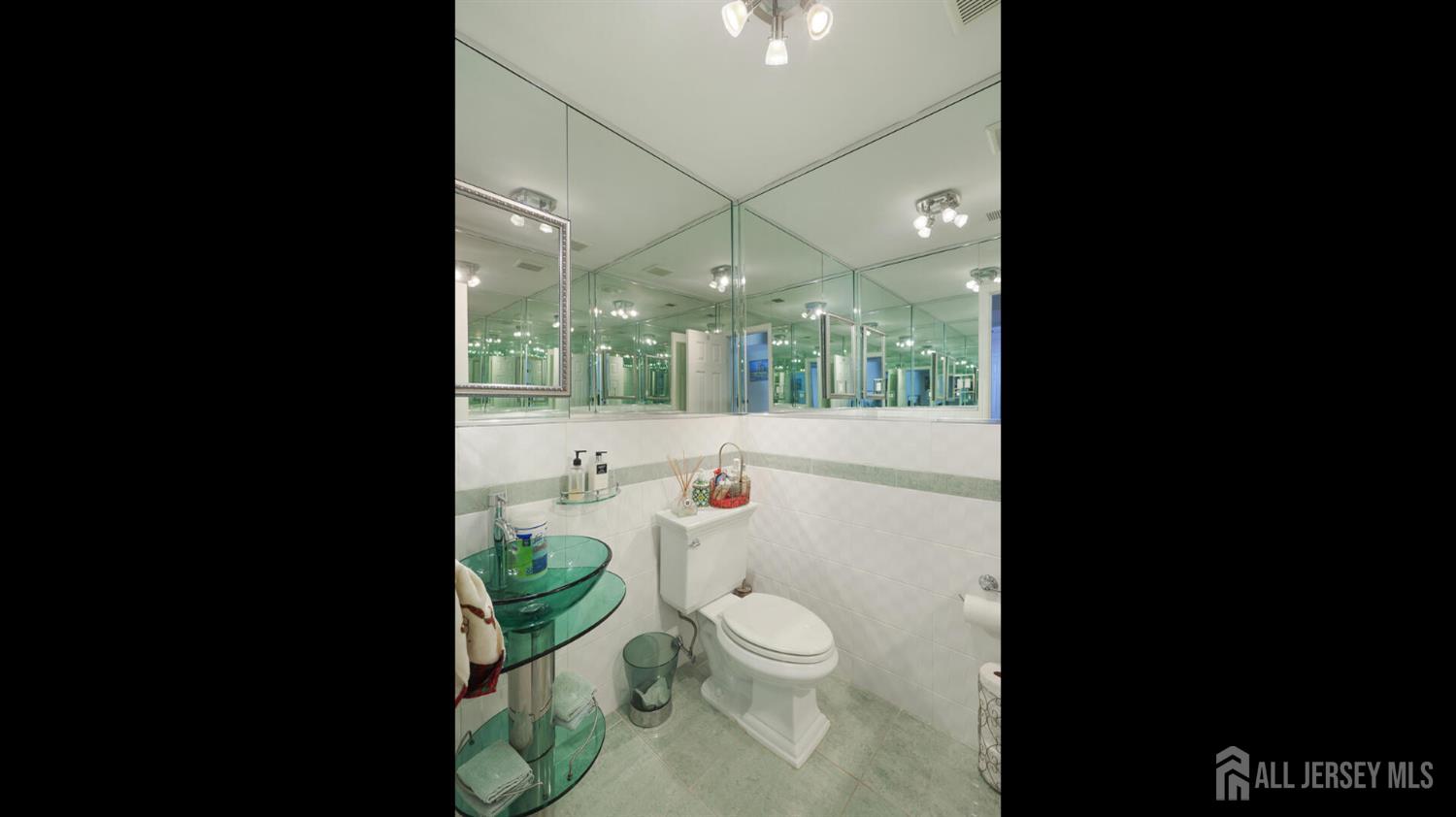 142 Monmouth Road Monroe Township, NJ 08831 - Photo 21 of 33 a bathroom with a toilet a sink and mirror