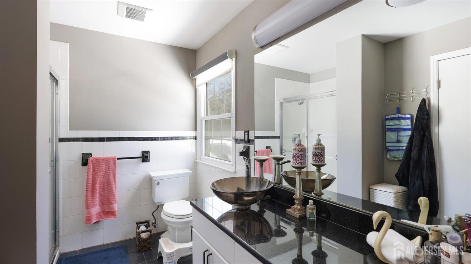142 Monmouth Road Monroe Township, NJ 08831 - Photo 23 of 33 a bathroom with a sink vanity mirror and toilet