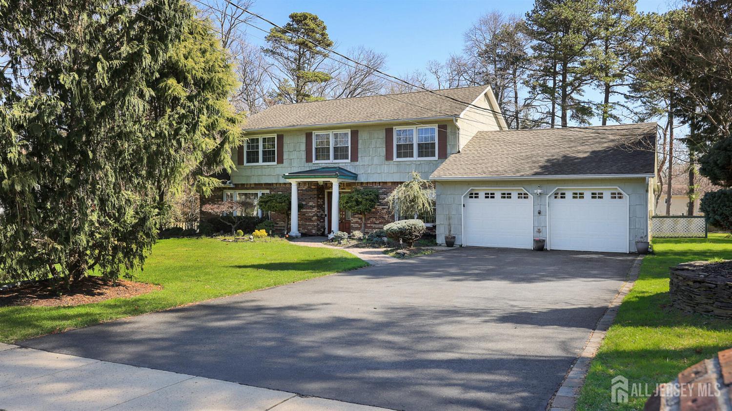 142 Monmouth Road Monroe Township, NJ 08831 - Photo 4 of 33 a view of a house with a yard and a garden