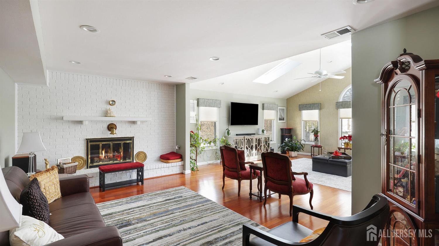 142 Monmouth Road Monroe Township, NJ 08831 - Photo 8 of 33 a living room with fireplace furniture and a flat screen tv