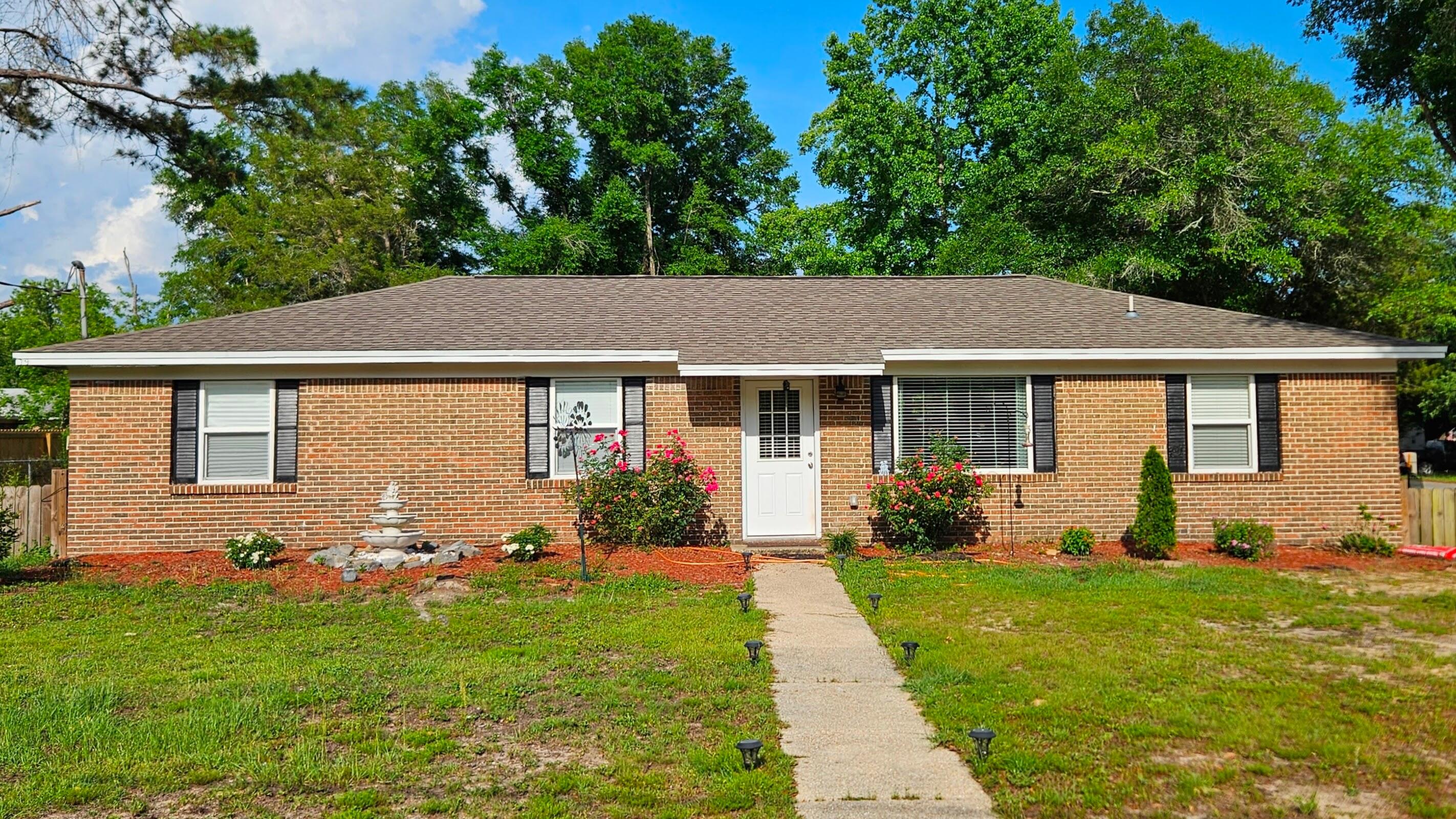 a view of a house with a yard and plants