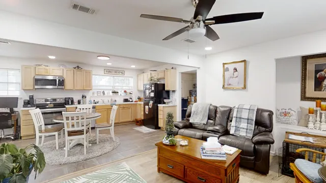 a living room with furniture kitchen view and a dining table