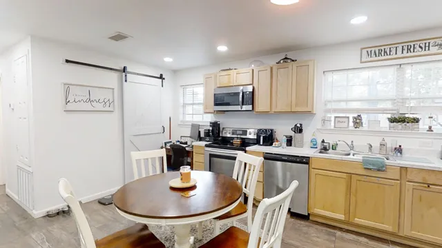 a kitchen with a sink stove and microwave