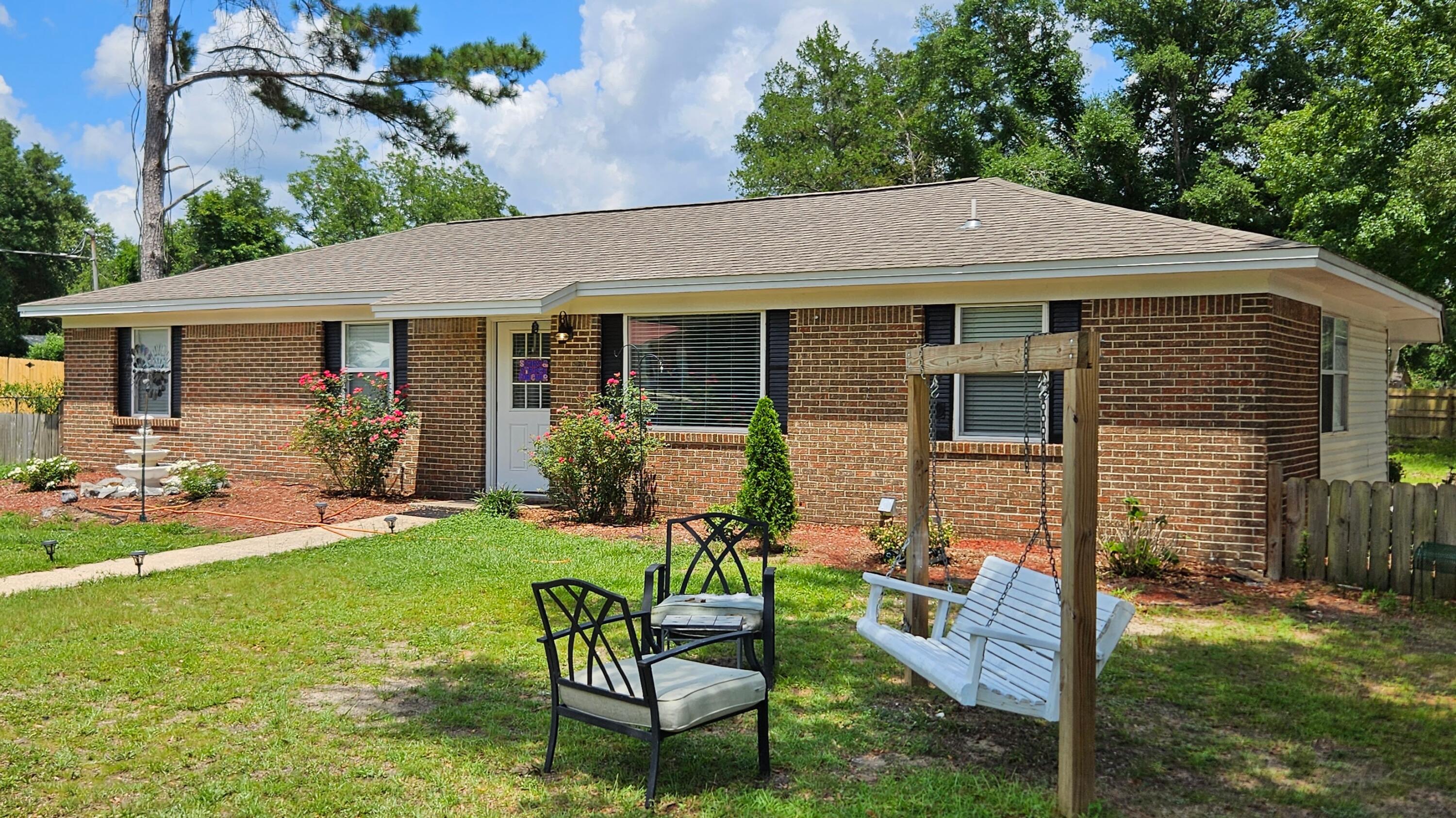 1202 Sunshine Drive Crestview, FL 32539 - Photo 2 of 38 a view of a house with backyard sitting area and garden